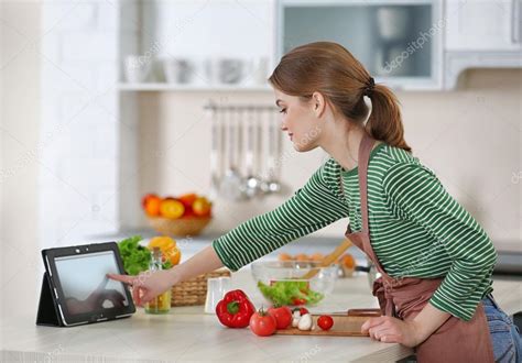 Young Woman Cooking In Kitchen Stock Photo By ©belchonock 102145648