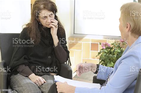 An Elderly Woman Being Counseled In An Office Stock Photo Download