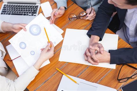 Business Papers Lying On The Table Near Corporate Leaders Stock Photo