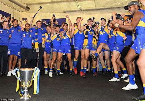 Stay tuned because the boys are putting something together for that. simpson on cyclone seroja and impact on mid west and mid west players. West Coast players drink beer from the premiership cup as ...