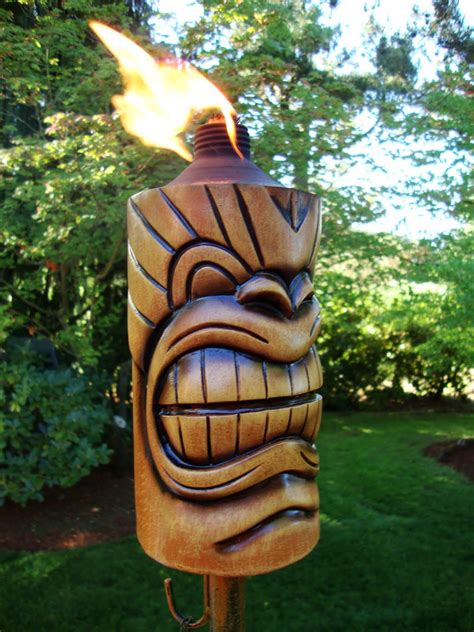 Tiki Torches Lit The Garden After The Sun Went Down Tiki Statues