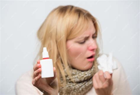 Premium Photo Dispenser Bottle Sick Woman Spraying Medication Into Nose Treating Common Cold