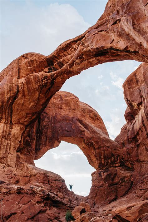 Human Standing In Double Arches Red Rock Southwest Desert Usa By