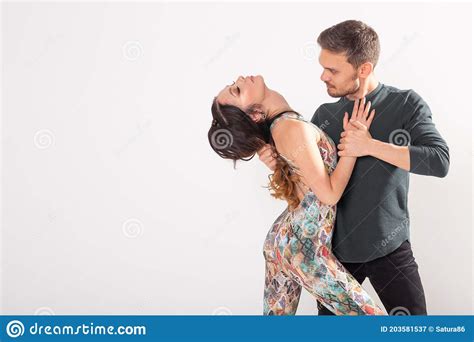 social dance bachata salsa kizomba zouk tango concept man hugs woman while dancing over