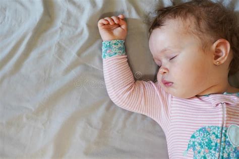 Peaceful Baby Lying On A Bed While Sleeping On Grey Background Stock Image Image Of Lying