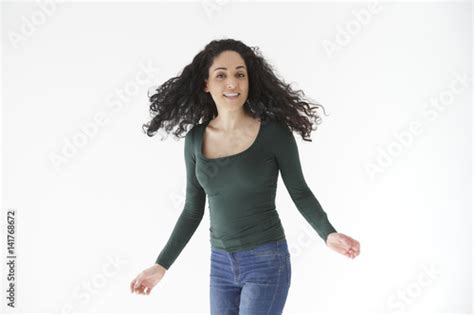 Natural Portrait Of Brunette Girl Shaking Her Hair On White Background