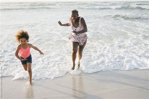Mother And Daughter Playing At The Beach By Bruce And Rebecca Meissner