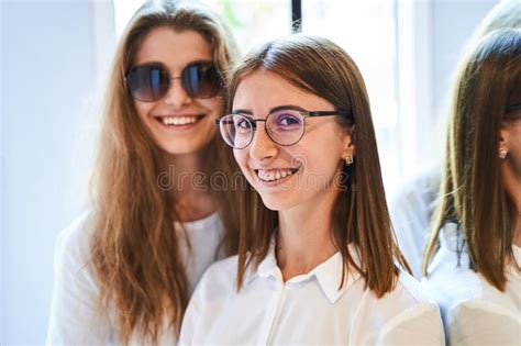 Cheerful Young Women In Glasses Standing In Optical Store Stock Image