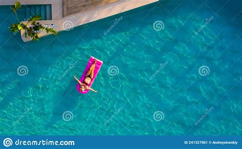 Woman Floating On Air Mattress In Swimming Pool Stock Image Image Of Bikini Beach 241327061