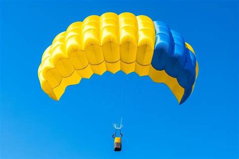 Premium Ai Image Parachutist With Yellow And Blue Parachute Against A