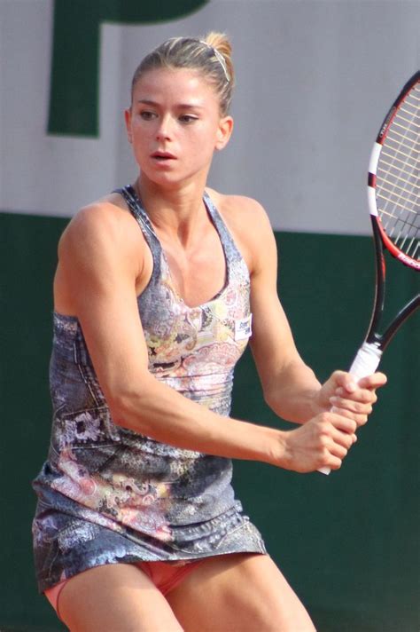 A Female Tennis Player In Action On The Court