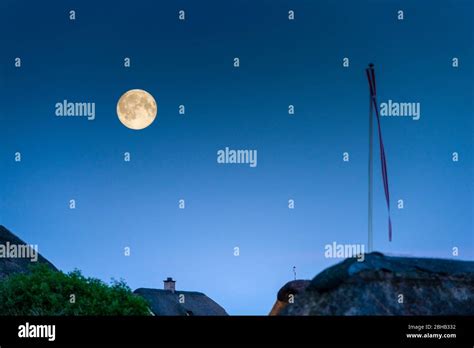 Denmark Jutland Ringkobing Fjord Full Moon Over Rooftops With Flag