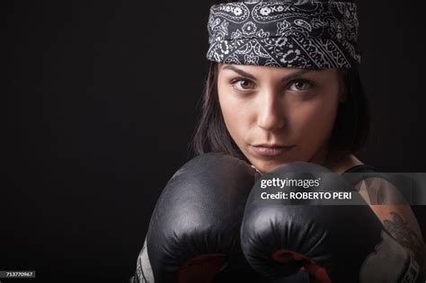 Portrait Of Young Woman Wearing Boxing Gloves In Fighting Stance High