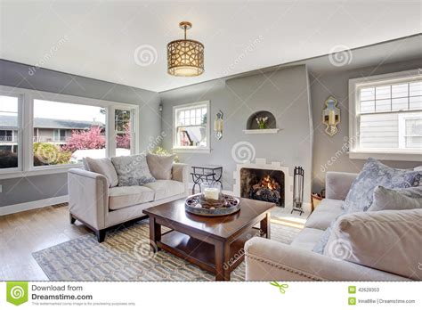 Light Grey Living Room With White Sofas And Fireplace