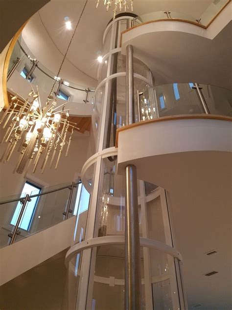 Dramatic Vuelift Round With Curved Balconies Glass Elevator House