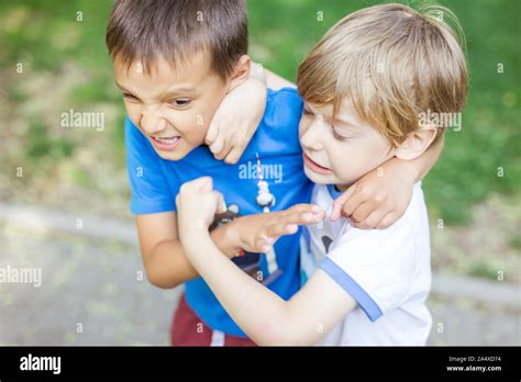Two Boys Fighting Outdoors Friends Wrestling In Summer Park Siblings