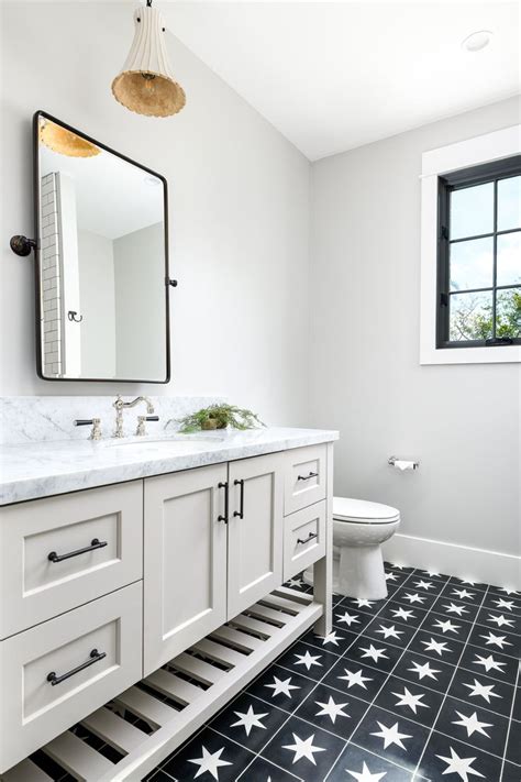 White bathroom floor tiles with small black insets can effectively ground the floor space, keeping it distinct from white walls. Black ceramic tile with white star pattern is just the ...