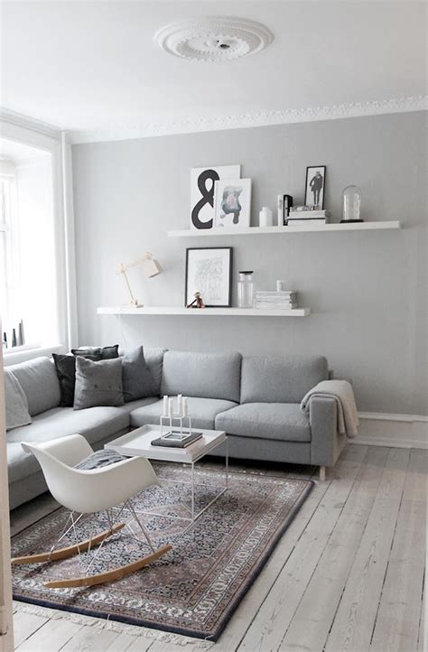 A white fireplace and ceiling beams balance dark walnut floors. decordots: Interior inspiration | Grey walls