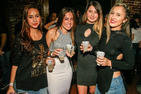 four latinas holding drinks