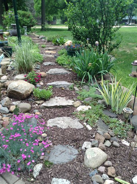Soften the hard edges of stone steps, paths, or patios with tough but pretty ground covers that can withstand more than a little stomping. This garden area has stones for steps on our slope in ...