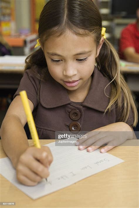 Girl Writing At Desk High Res Stock Photo Getty Images