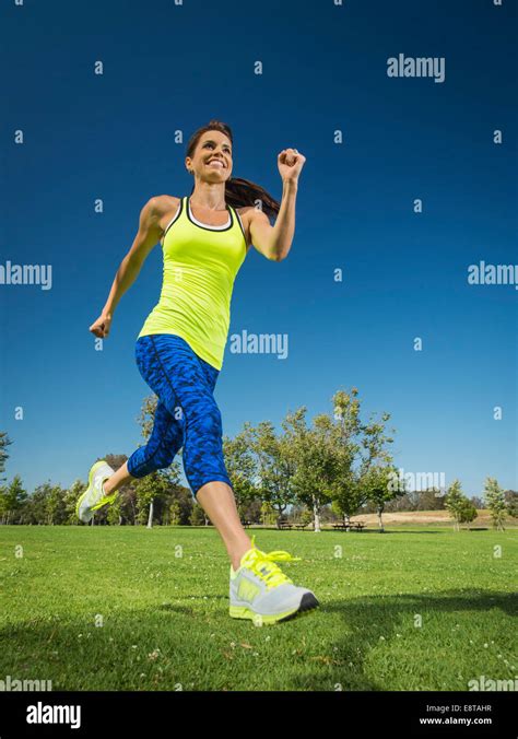 Mixed Race Woman Jogging In Park Stock Photo Alamy