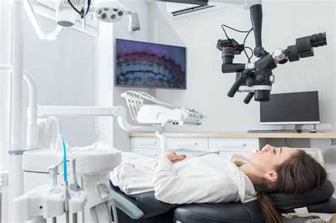 Premium Photo Using Dental Microscope Treating Patient Teeth At