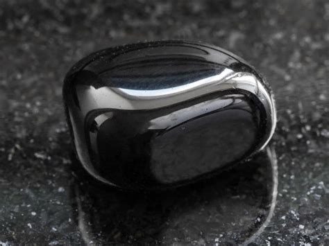 Polished Black Onyx Gemstone On Dark Jewelry Guide