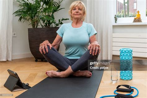 Senior Woman Doing Lotus Position After Long Workout High Res Stock