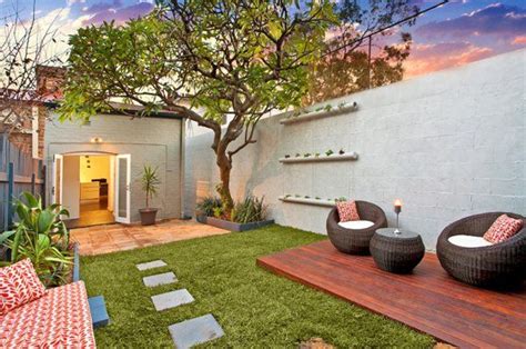 An Outdoor Living Area With Grass And Furniture