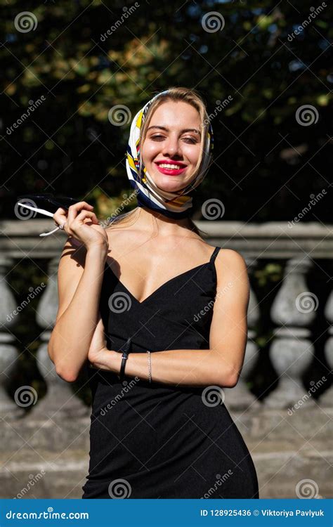 Classy Smiling Blonde Woman With Red Lips Wearing Shawl And Black Dress Posing With Sun Light