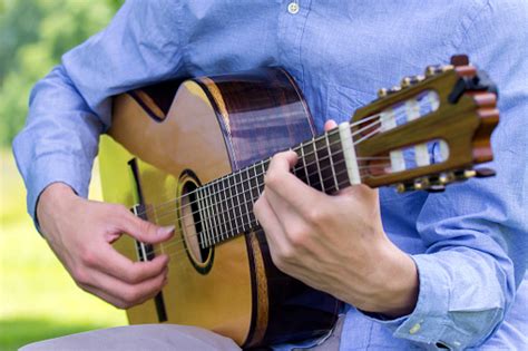 Young Male Playing A Classic Guitar Outside Stock Photo Download