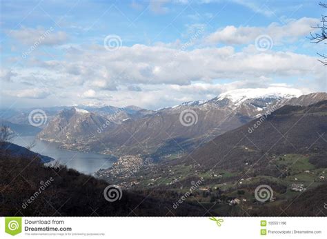 Panoramic Image Of Valcamonica With Lake Iseo And In The Background The