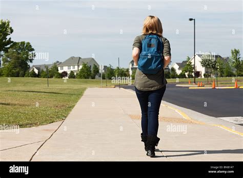 Female High School Student Walking Along Pavement Stock Photo Alamy