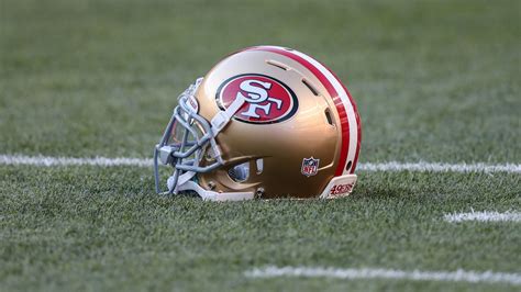 Golden Color Helmet With San Francisco 49ers Log On Green Grass 4k Hd