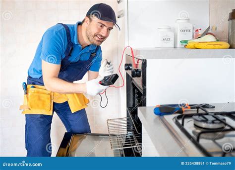 One Expert Repairman Fixing A Broken Kitchen Oven Stock Image Image