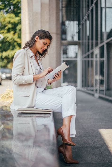 Businesswoman Using Digital Tablet Outdoors By Stocksy Contributor