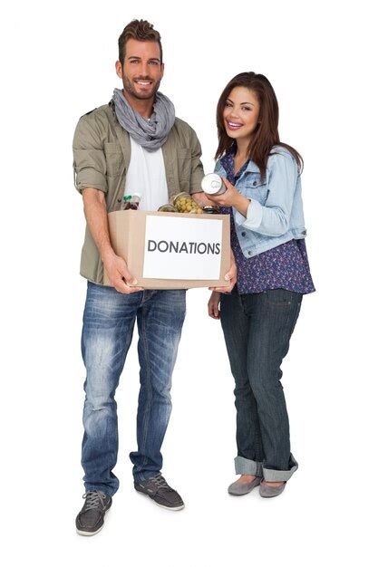 Premium Photo Portrait Of A Smiling Young Couple With Donation Box
