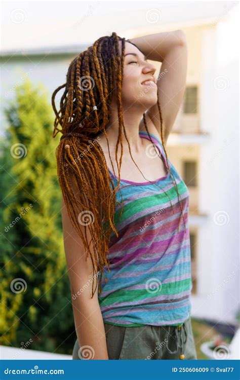 A Girl With A Dreadlocked Hairstyle Poses In The Summer Outdoor Stock