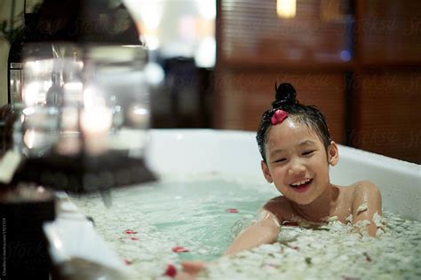 Cute Asian Little Girl Bathing In A Bathtub Full Of Petals Porchaoshu Li