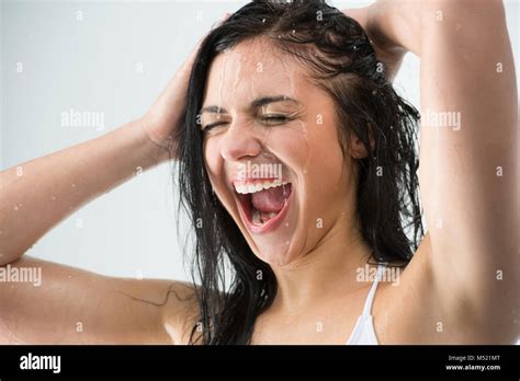 Woman Washing Her Head While Showering With Happy Smile And Water Splashing Beautiful Caucasian