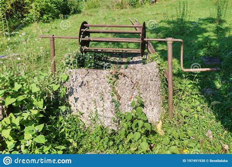 Abandoned Well In A Field Overgrown With Green Ivy Stock Photo Image