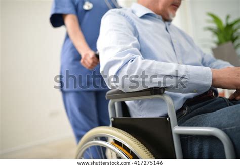 Nurse Pushing Injured Patient On Wheelchair Stock Photo Edit Now