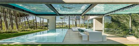 Elevated Glass Bottomed Pool Hovers Over A Second Pool In The Hip Wall