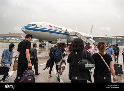 Beijing China Passengers Boarding An Air China Plane At The Beijing