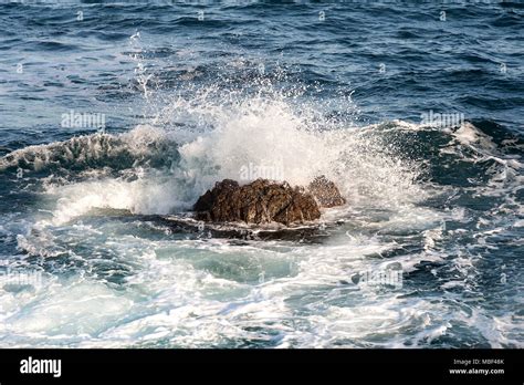 Ocean Wave Splashing When Hit At A Large Stone In The Water Splash High