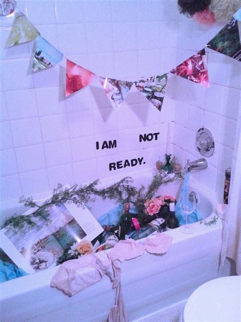 A Bath Tub Filled With Lots Of Items Next To A Sign That Says I Am Not