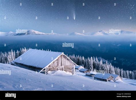 Fantastic Winter Landscape With Wooden House In Snowy Mountains Starry