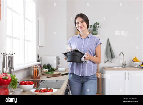 Beautiful Young Woman Cooking Dinner In Kitchen Stock Photo Alamy