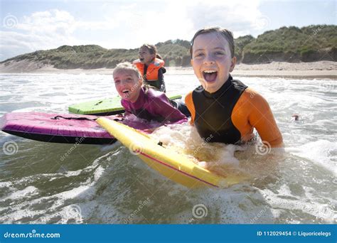 Girls Bodyboarding In The Sea Stock Photo Image Of Coast Beach